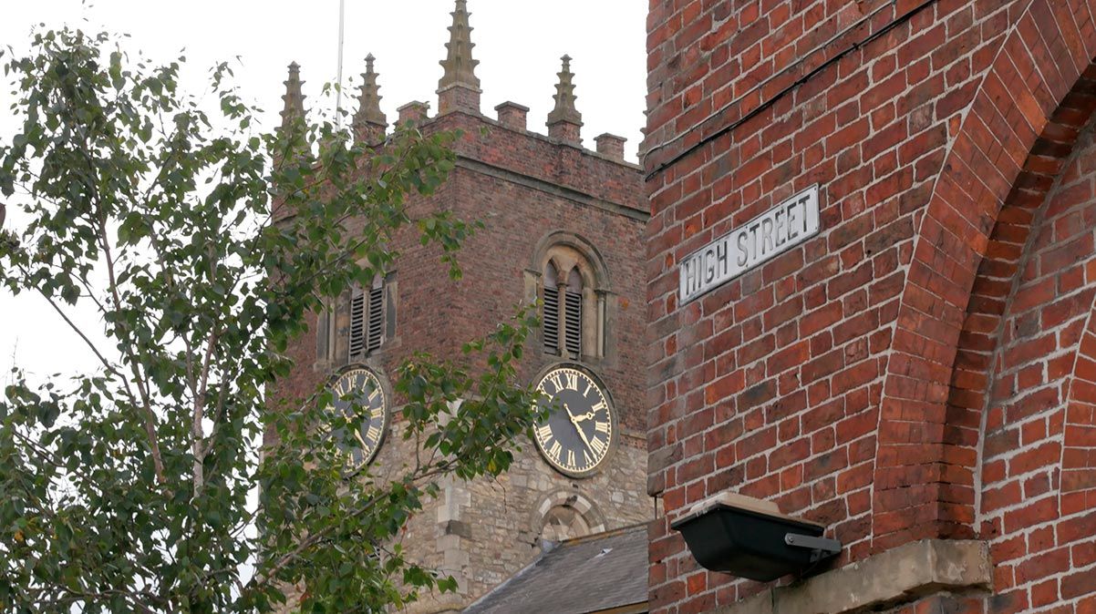 All Saints Church tower in Market Weighton viewed from the High Street