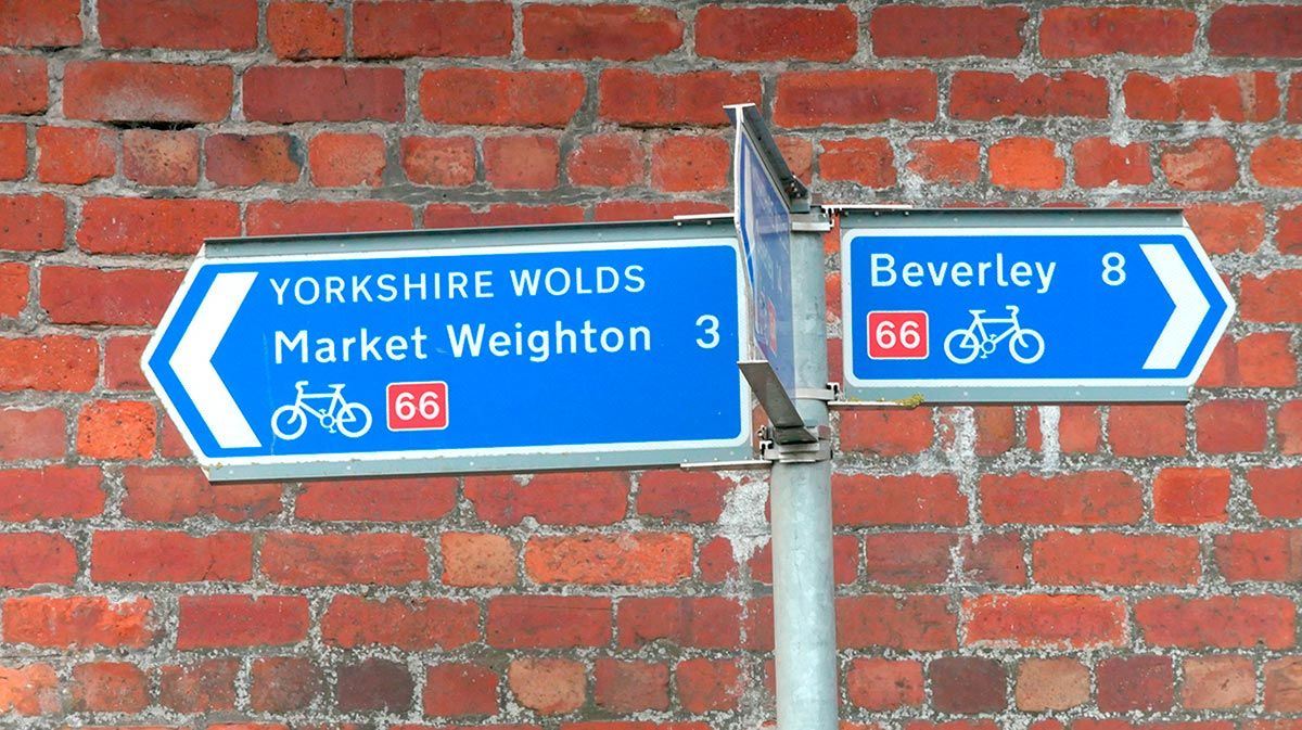 Yorkshire Wolds Way Cycle Route 66 road sign showing Market Weighton and Beverley directions