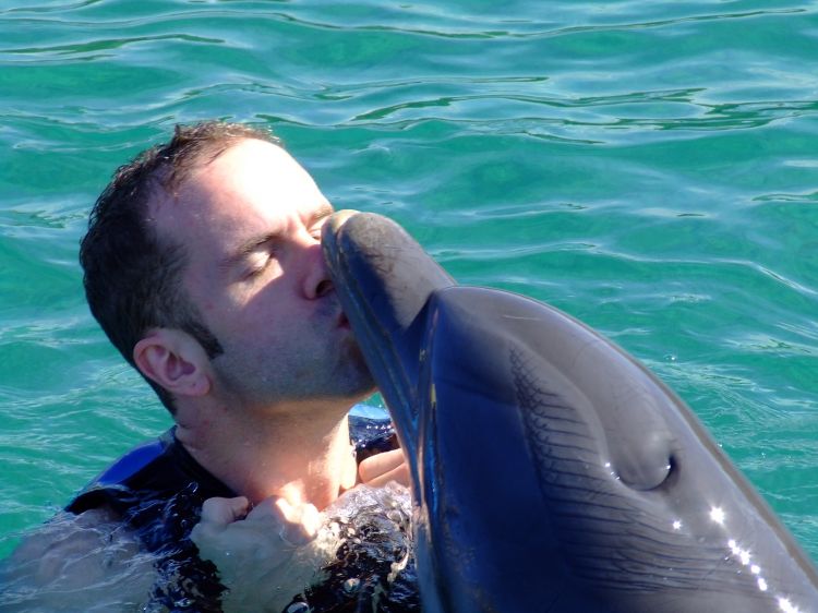 Alex kisses a Dolphin